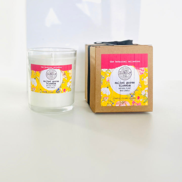 Candle and packaging with floral design on a white background
