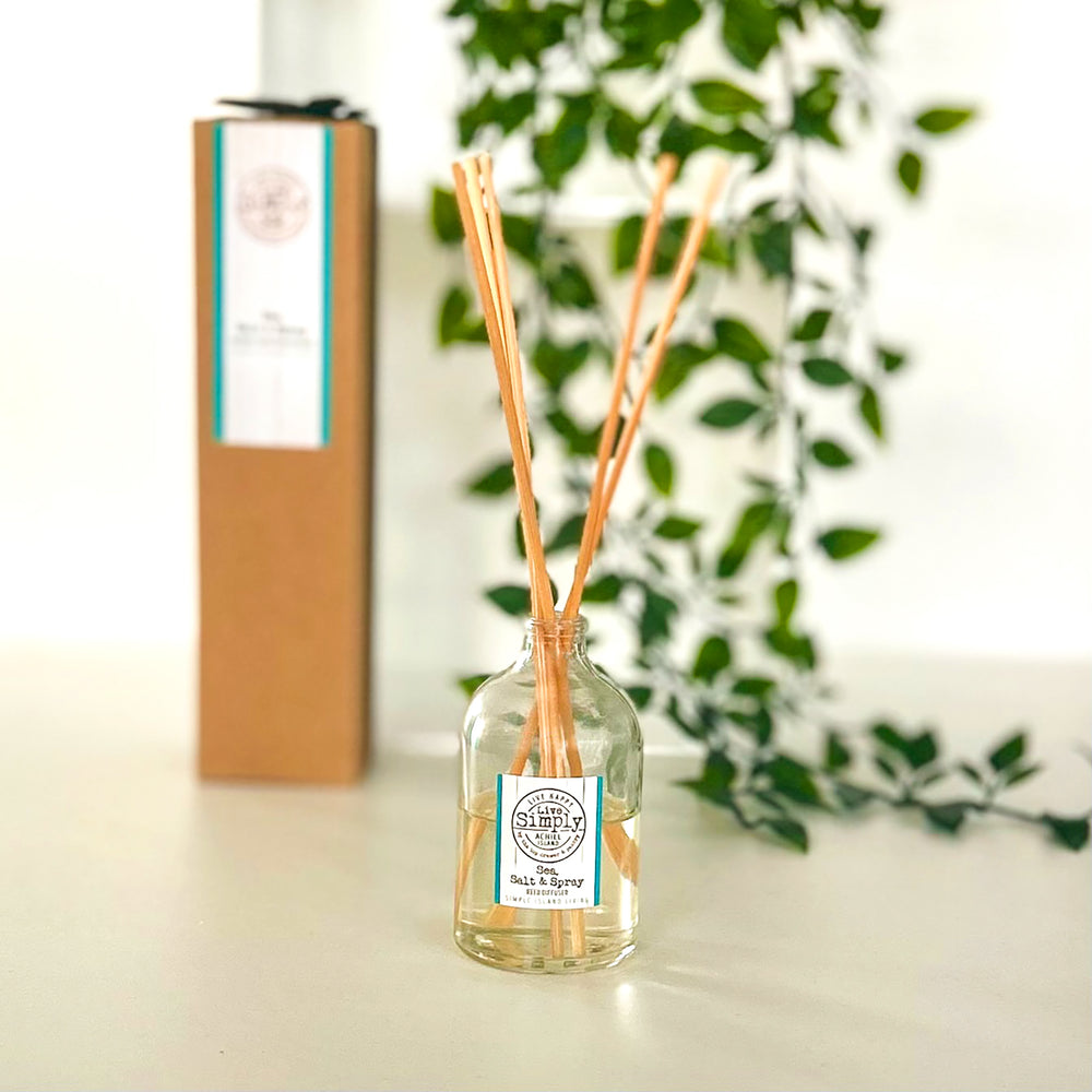 Diffuser with wooden sticks and a box in the background