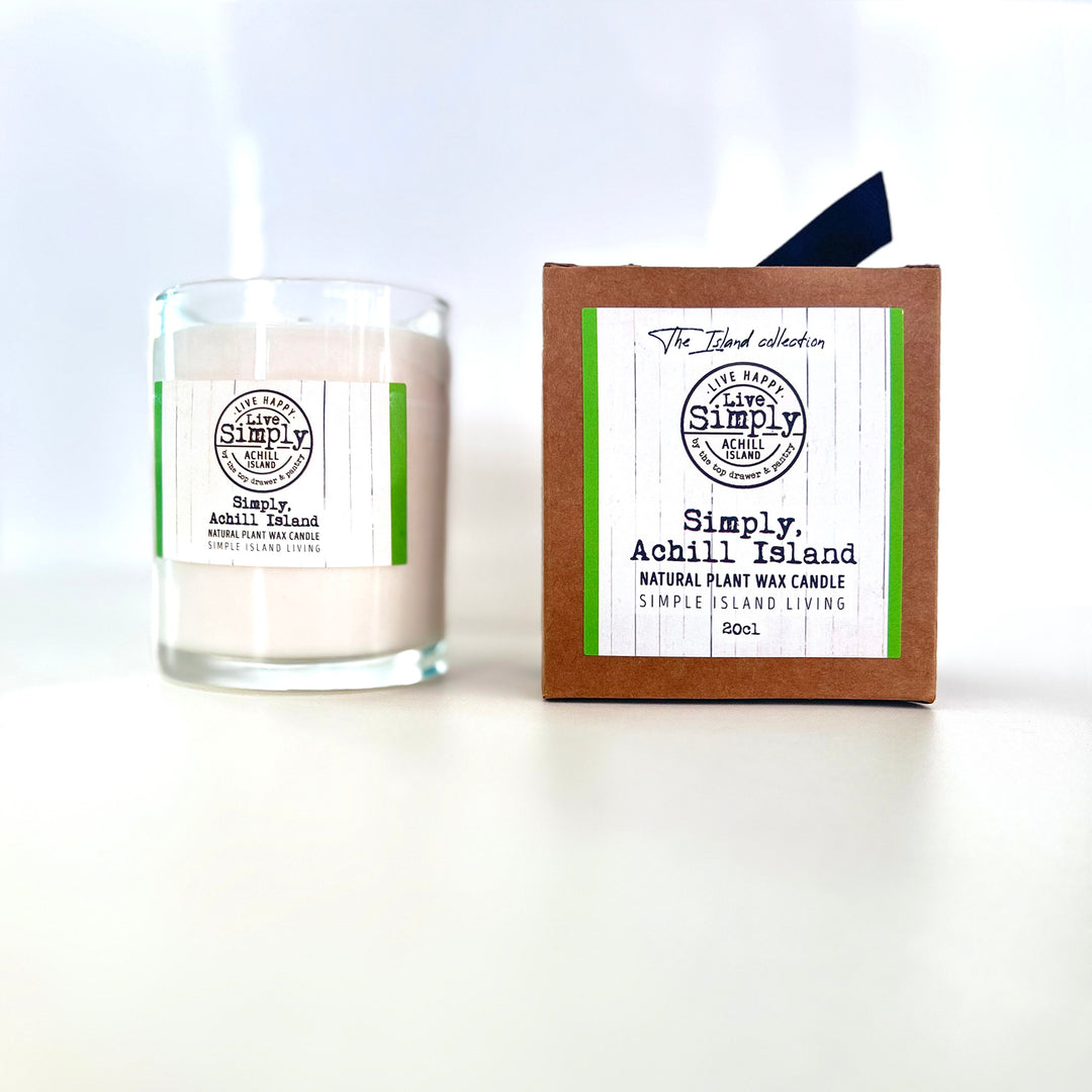 Candle and its packaging with 'Simply, Achill Island' branding on a white background