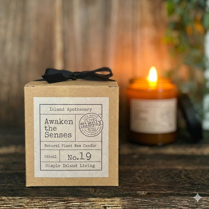 Awaken the Senses (No. 28) hand-curated apothecary candle in a signature amber glass jar by Live Simply Apothecary, inspired by the vitality of Keel Beach.
