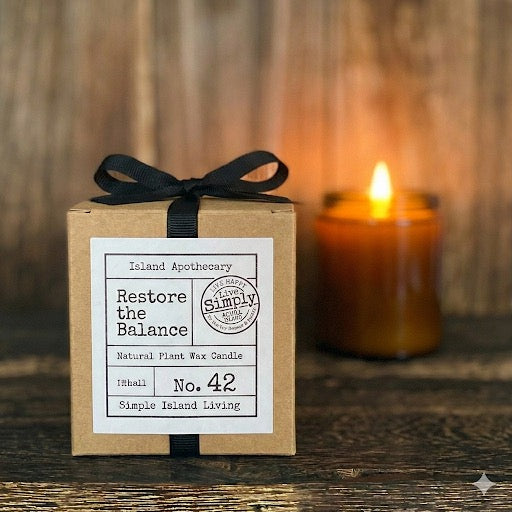 Close-up of the botanical label and premium natural plant wax of the Restore the Balance (No. 42) candle, featuring grounding notes of Amber and Leather.
• Caption: Hand-poured and strictly curated to capture the essence of Achill.